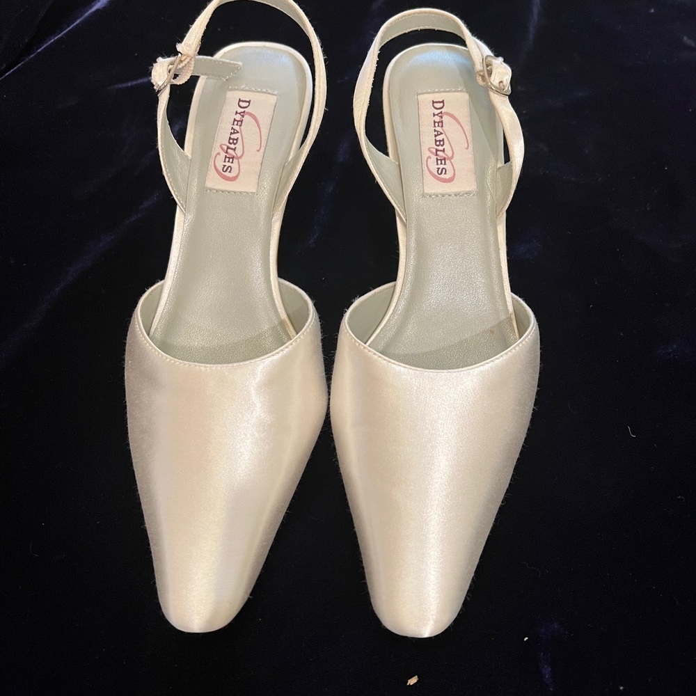 A pair of unused, unworn white satin sling back heels